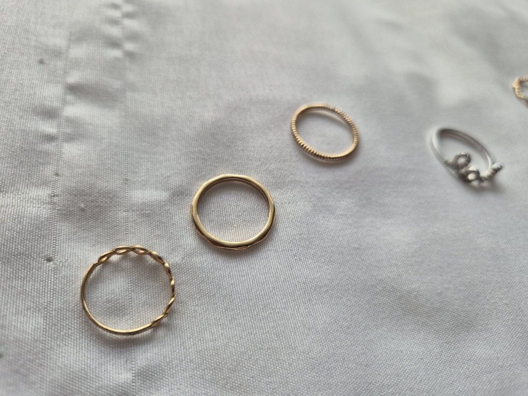 Minimalist Jewelry Gold Colored Ring Set (Category: Rings) located in Pasig City. Submitted by joejoejoes (Listing ID 1423046803, Image 2). Description: Class A Rings (Left to Right): 1. infinity ring, often stylized as a chain link or infinity motif ban (1.5cm inner diameter) 2. solid gold colored band, crafted with a textured, molten, or hammered finish (1.5cm inner diameter) 3. minimalist twisted rope design ring (1.5 cm inner diameter) 4. ste