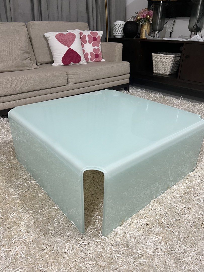 Modern Square Glass Coffee Table (Category: Tables & Sets) located in Makati City. Submitted by curatedfindsbydei (Listing ID 1422915336, Image 3). Description: Originally P15,000, now selling for P7,500 only. Colors available: White and black. Measurements: 80 x 80 x 30cm. Stylish square coffee table with a unique, curved design. Perfect for living rooms, offering a modern and minimalist aesthetic. Its clean lines and color make it a versatile p