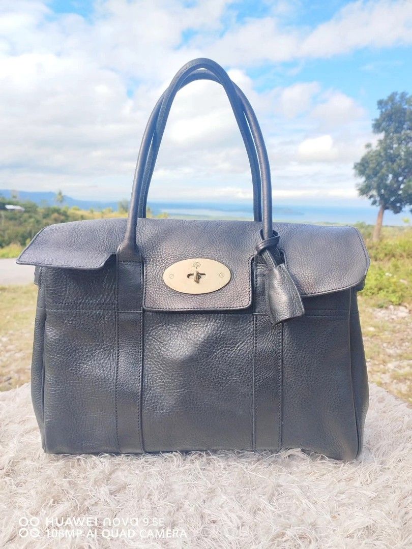 Mulberry Bayswater Black Leather Handbag (Category: Luxury Bags & Wallets) located in Cebu City. Submitted by tlisurplus (Listing ID 1422947486, Image 1). Description: - Authentic Mulberry Bayswater handbag - Black leather - Signature postman's lock closure - Detachable clochette with keys - Interior zipped and slip pockets - Made in England - Classic grain texture - Spacious interior.