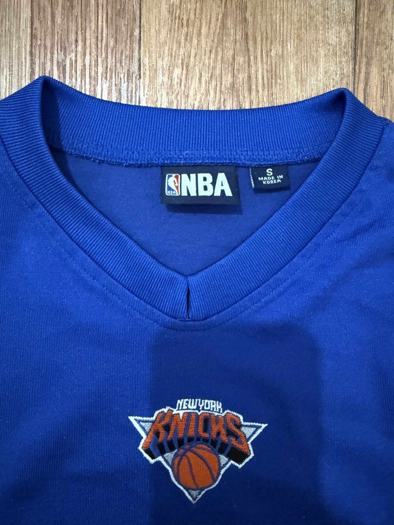 NBA New York Knicks Jersey (Category: Activewear) located in Quezon City. Submitted by thrifttogreatness (Listing ID 1422913316, Image 2). Description: - Authentic NBA New York Knicks jersey - Features a blue base with orange accents - Includes the Knicks logo on the chest - NBA logo on the sleeve - Classic V-neck design - Size: S - Made in Korea.