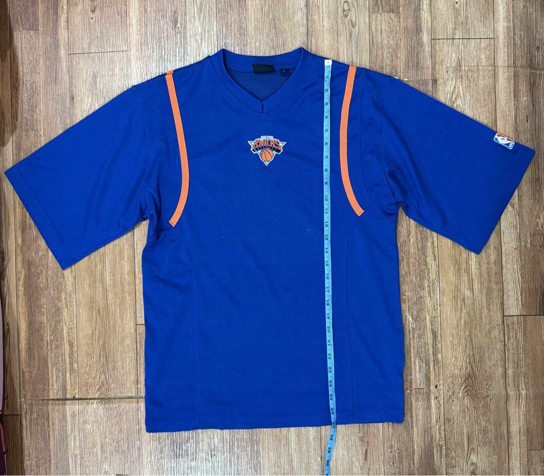 NBA New York Knicks Jersey (Category: Activewear) located in Quezon City. Submitted by thrifttogreatness (Listing ID 1422913316, Image 1). Description: - Authentic NBA New York Knicks jersey - Features a blue base with orange accents - Includes the Knicks logo on the chest - NBA logo on the sleeve - Classic V-neck design - Size: S - Made in Korea.