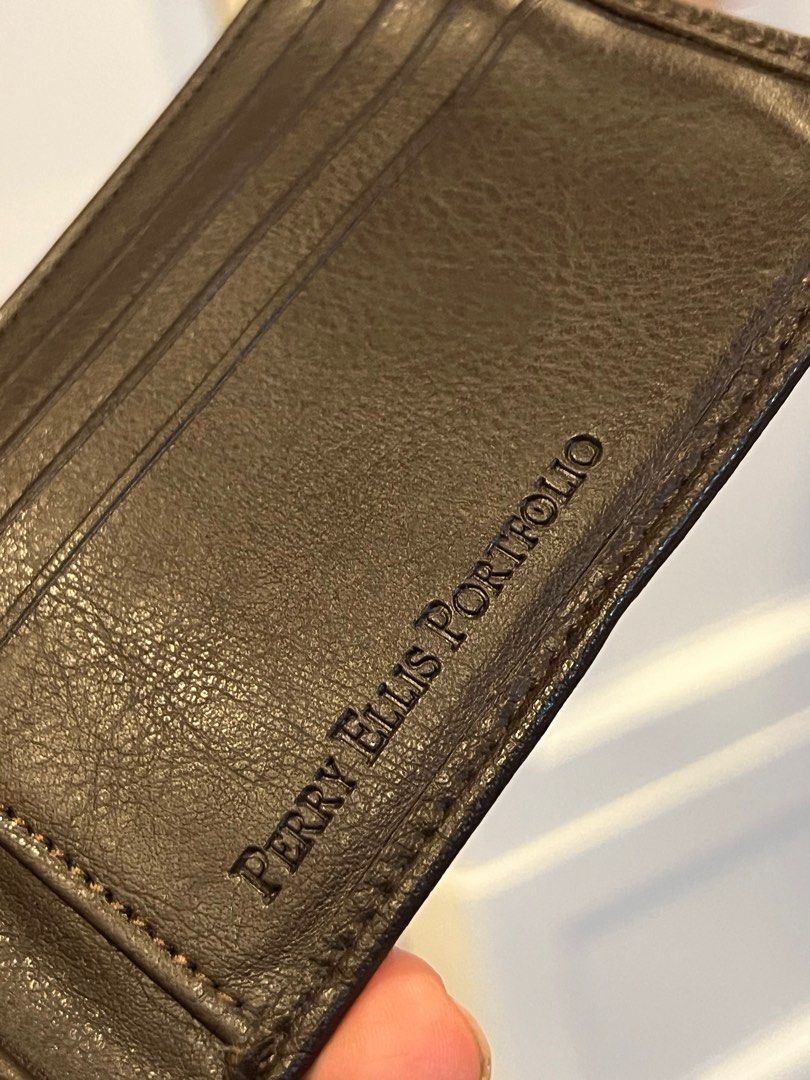 Perry Ellis Portfolio Brown Wallet (Category: Wallets & Card Holders) located in Manila. Submitted by gee0505 (Listing ID 1423067279, Image 1). Description: - Brand: Perry Ellis Portfolio - Color: Brown - Type: Bi-fold wallet - Features: Multiple card slots, clear ID window - Material: Textured - Design: Classic and functional - Details: Brand name embossed inside.