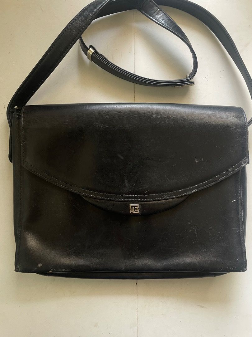 Pierre Balmain Black Shoulder Bag (Category: Luxury Bags & Wallets) located in Cebu City. Submitted by junneichan (Listing ID 1422968210, Image 1). Description: Black shoulder bag by Pierre Balmain. Features a flap closure with a silver-tone logo detail. Includes an adjustable shoulder strap. The interior has a zippered pocket and a brand label. The bag has some signs of wear. flaws: some cracking on leather on the inner of the bag only, all oute