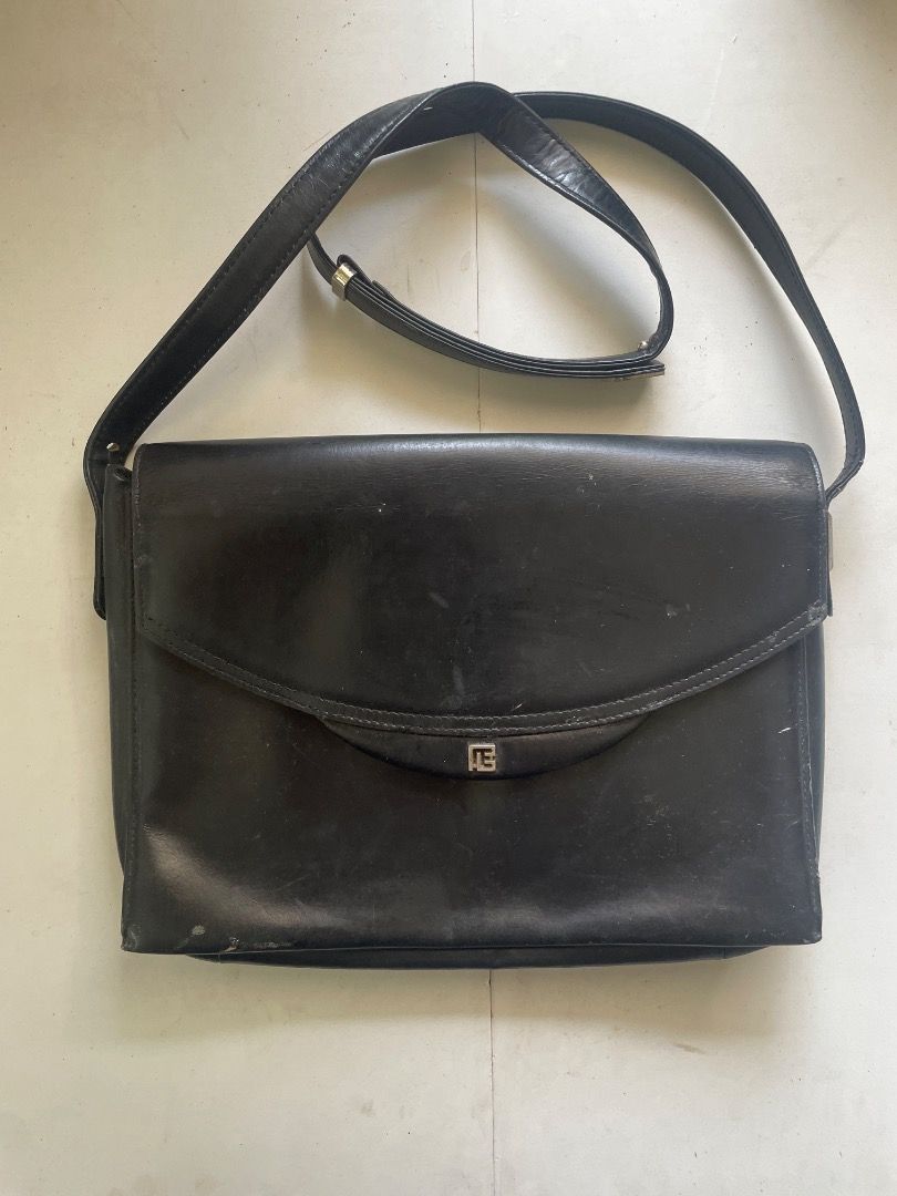 Pierre Balmain Black Shoulder Bag (Category: Luxury Bags & Wallets) located in Cebu City. Submitted by junneichan (Listing ID 1422968210, Image 3). Description: Black shoulder bag by Pierre Balmain. Features a flap closure with a silver-tone logo detail. Includes an adjustable shoulder strap. The interior has a zippered pocket and a brand label. The bag has some signs of wear. flaws: some cracking on leather on the inner of the bag only, all oute