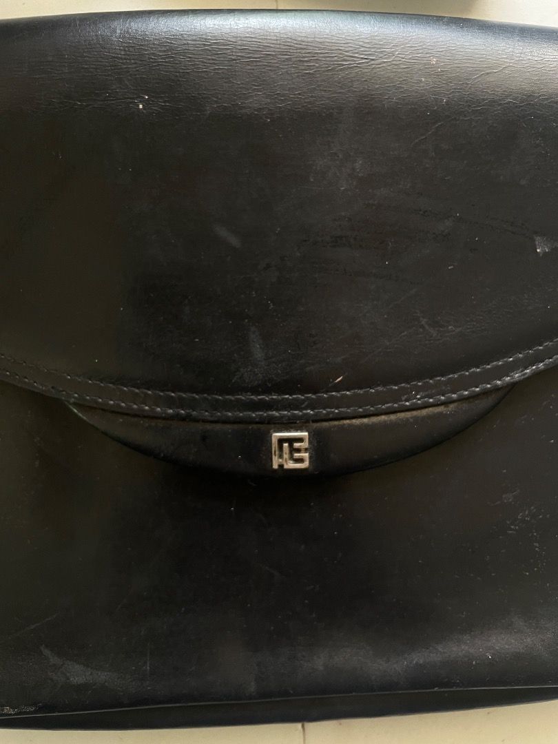 Pierre Balmain Black Shoulder Bag (Category: Luxury Bags & Wallets) located in Cebu City. Submitted by junneichan (Listing ID 1422968210, Image 2). Description: Black shoulder bag by Pierre Balmain. Features a flap closure with a silver-tone logo detail. Includes an adjustable shoulder strap. The interior has a zippered pocket and a brand label. The bag has some signs of wear. flaws: some cracking on leather on the inner of the bag only, all oute
