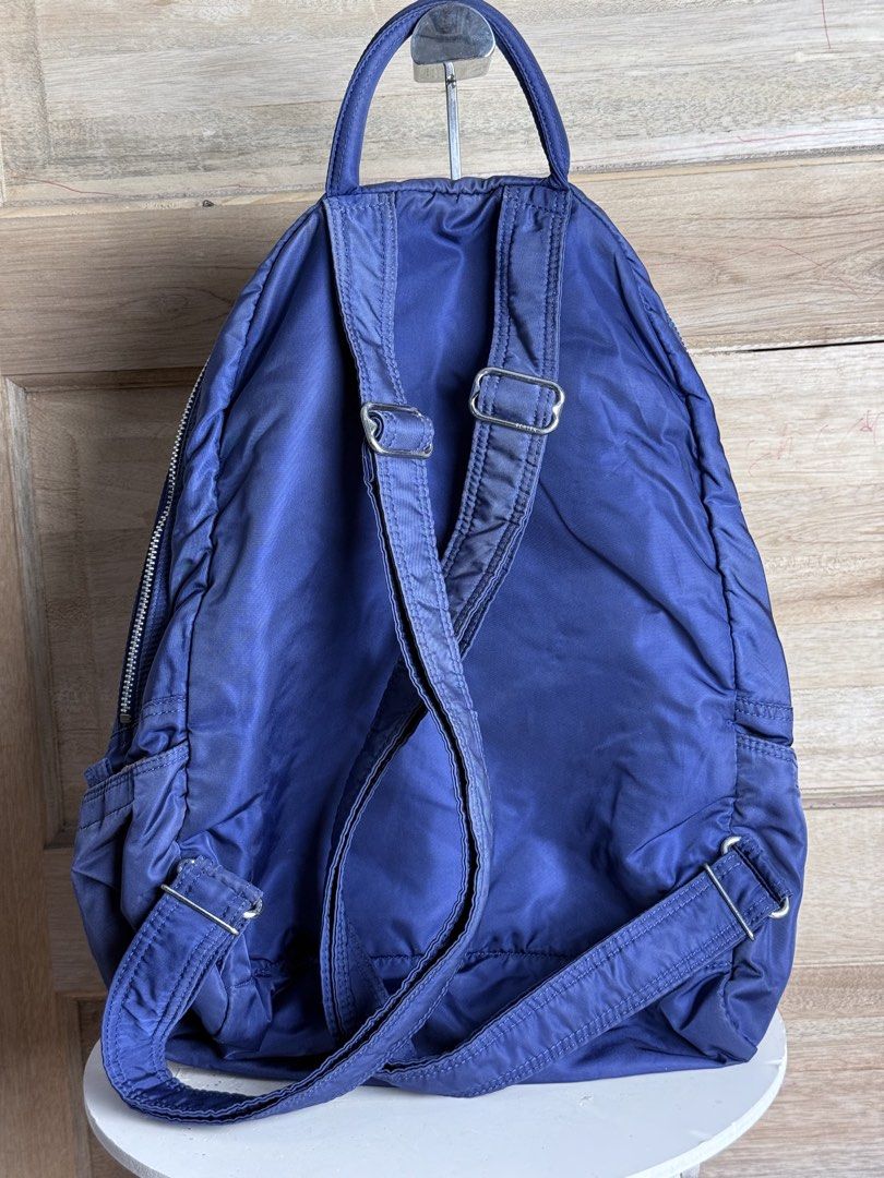 Porter International Navy Backpack (Category: Backpacks) located in San Pablo. Submitted by zzz.archvs (Listing ID 1423008670, Image 3). Description: - Navy blue Porter International backpack - Front zip pocket - Top handle - Adjustable shoulder straps - Orange interior - Zipper closure - Porter International logo on front - Unique zipper design - Made of nylon.