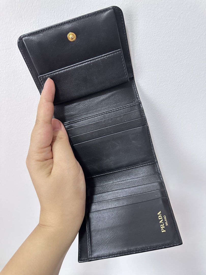 Prada Saffiano Leather Wallet (Category: Luxury Bags & Wallets) located in Quezon City. Submitted by general_cleanup (Listing ID 1423017983, Image 3). Description: - Authentic Prada wallet - Black Saffiano leather - Gold Prada logo - Includes: original box, dust bag, authenticity card, and shopping bag - Interior: multiple card slots and coin compartment - AURA Blockchain Consortium certified.