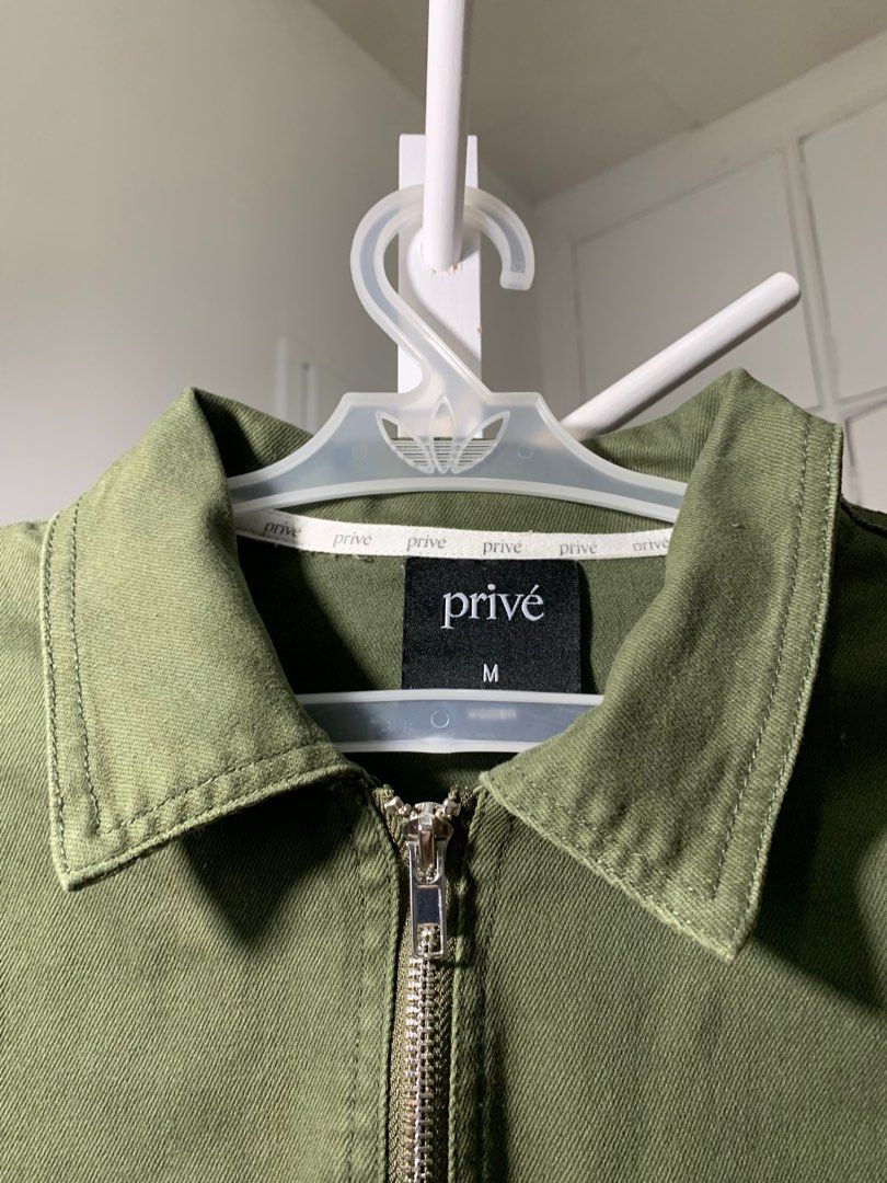 Privé Olive Green Jacket (Category: Coats, Jackets and Outerwear) located in Quezon City. Submitted by declutterwithm (Listing ID 1423020313, Image 2). Description: - Olive green Privé Alliance jacket - Size: Medium - Full-length zipper - Unique pocket design with yellow accent - Privé branding - Collared neckline - Long sleeves .