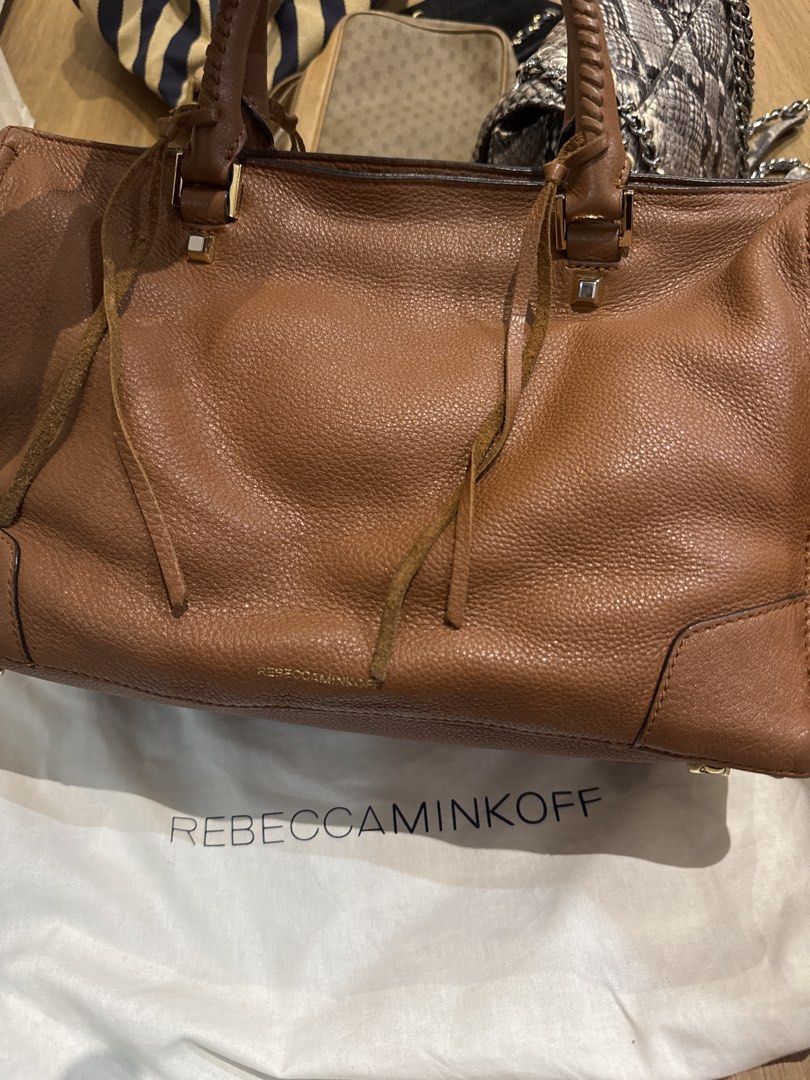 Rebecca Minkoff Brown Leather Handbag (Category: Luxury Bags & Wallets) located in Manila. Submitted by declutterkween14 (Listing ID 1422958112, Image 3). Description: - Brown leather handbag - Top handle and zip closure - Front zip pocket - Decorative tassels - Gold-toned hardware - Structured shape - Pebbled leather finish.