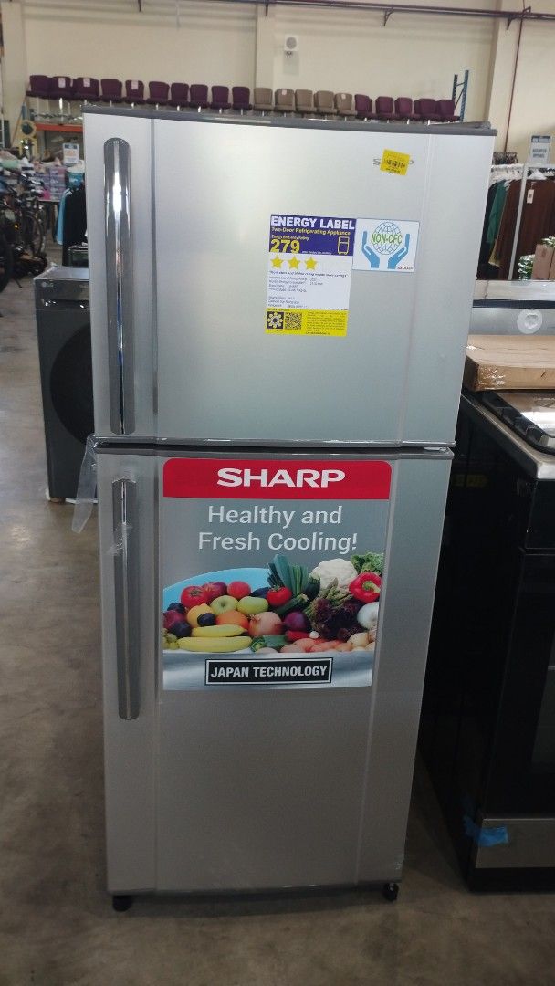 Sharp Refrigerator (Category: Refrigerators and Freezers) located in Caloocan City. Submitted by dhiony (Listing ID 1422937495, Image 1). Description: - Sharp refrigerator with top freezer - Silver finish - Features 'Healthy and Fresh Cooling' sticker - Energy label: 270 kWh - Standard household size - Includes door handles.