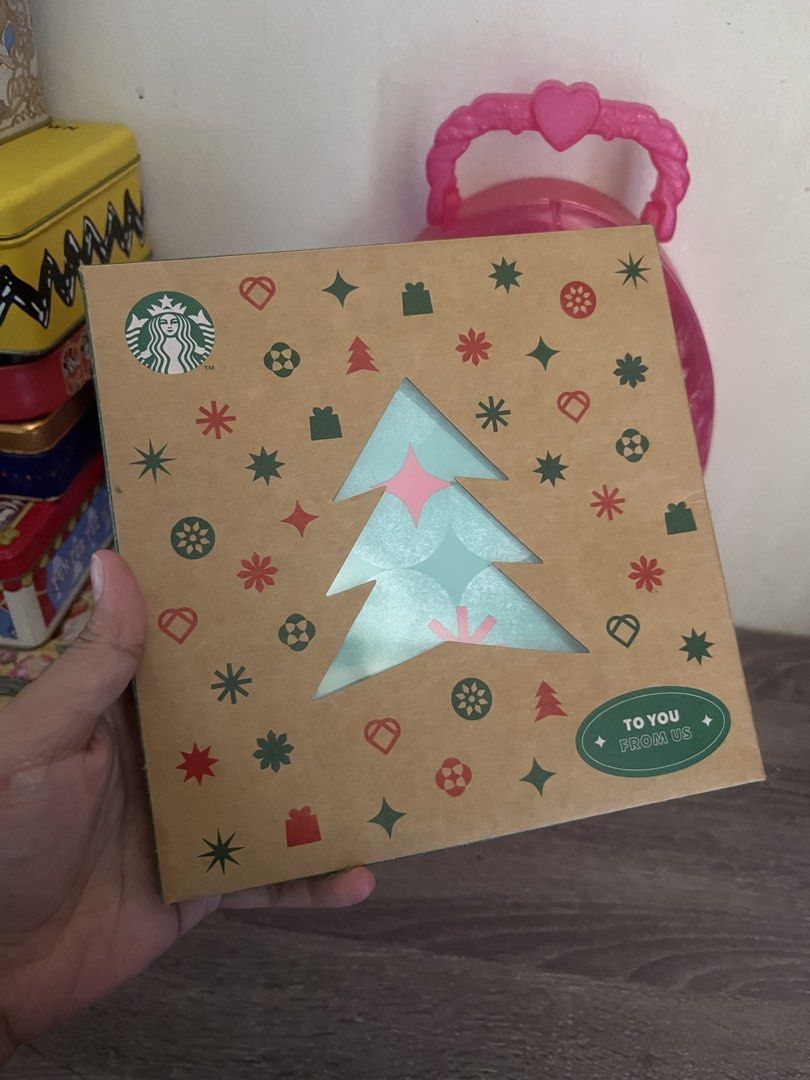 Starbucks Christmas Plate with Box (Category: Dinnerware & Cutlery) located in Cebu City. Submitted by abct1 (Listing ID 1422960188, Image 1). Description: - Starbucks Christmas plate - Festive green design with red star accents - Includes matching Christmas-themed box - Box features a Christmas tree cutout - Plate has the Starbucks logo - Ideal for the holiday season.