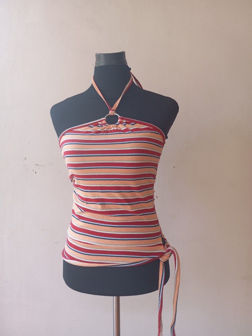 Striped Halter Top (Category: Sleeveless) located in Manila. Submitted by beenab (Listing ID 1422960055, Image 1). Description: - Striped halter top in red, orange, and blue. - Features a stylish ring detail at the neckline. - Adjustable side ties for a perfect fit. - Sleeveless design. -Y2K -FUNKY - Made from a comfortable, stretchy material. - Versatile piece, dress it up or down..