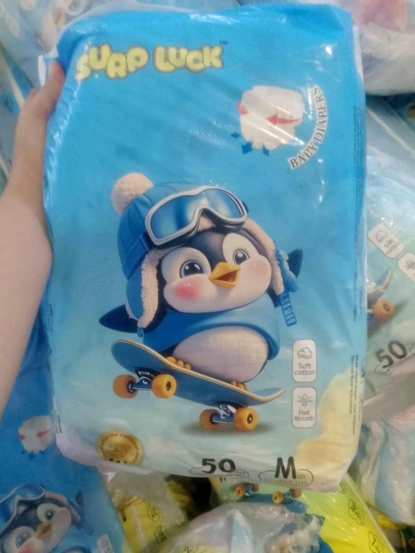 Surp Luck Baby Diapers Medium 50pcs (Category: Diapers & Baby Wipes) located in Quezon City. Submitted by moonchayo (Listing ID 1422997294, Image 1). Description: - Surp Luck baby diapers - Size: Medium - 50 pieces per pack - Adorable penguin design - Soft cotton material - Fast absorbing - Available in blue and yellow packaging.