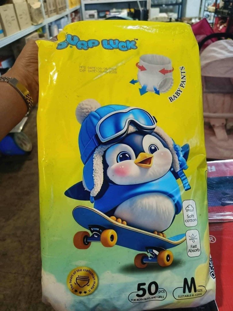 Surp Luck Baby Diapers Medium 50pcs (Category: Diapers & Baby Wipes) located in Quezon City. Submitted by moonchayo (Listing ID 1422997294, Image 3). Description: - Surp Luck baby diapers - Size: Medium - 50 pieces per pack - Adorable penguin design - Soft cotton material - Fast absorbing - Available in blue and yellow packaging.