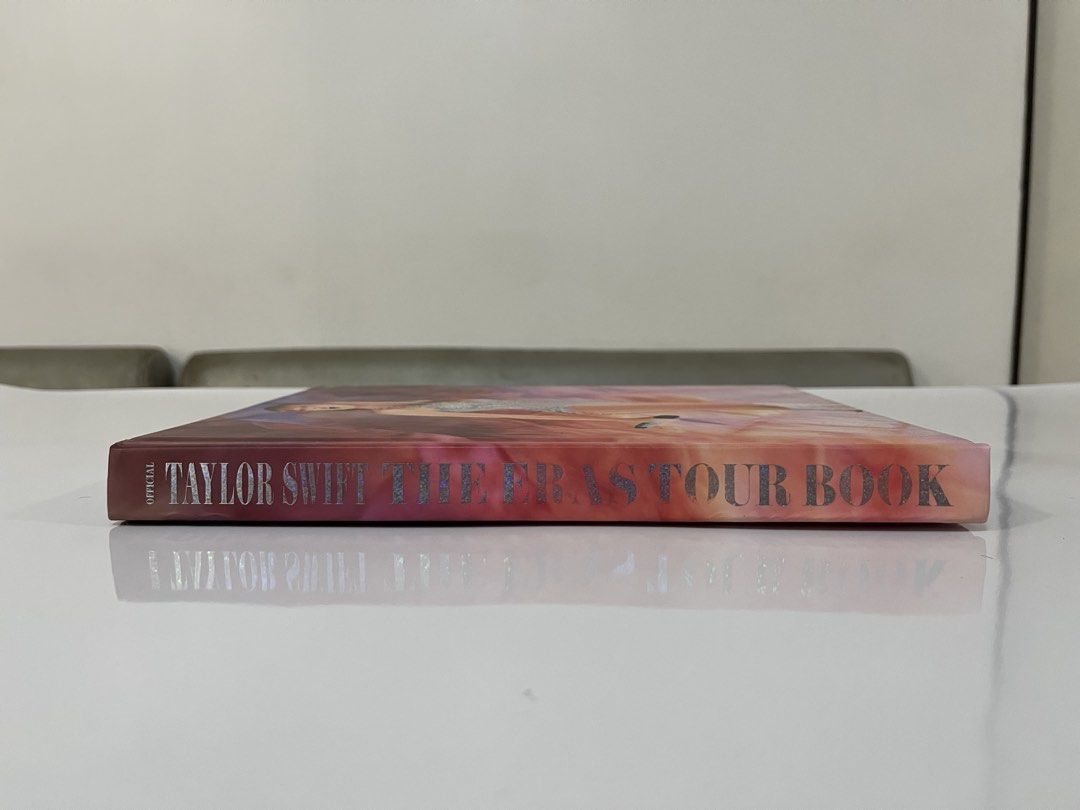 Taylor Swift The Eras Tour Book (Category: CDs & DVDs) located in Indang. Submitted by cyrelrdrgz_ (Listing ID 1422927562, Image 2). Description: - Official Taylor Swift The Eras Tour Book - Features stunning photos from the tour - Includes images from Lover, Fearless, and other eras - Contains a special message from Taylor Swift - Perfect for reliving the magic of the Eras Tour - Purchased via @glamourmerchph at Instagram.