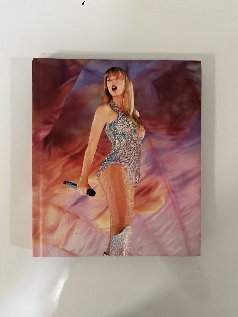 Taylor Swift The Eras Tour Book (Category: CDs & DVDs) located in Indang. Submitted by cyrelrdrgz_ (Listing ID 1422927562, Image 1). Description: - Official Taylor Swift The Eras Tour Book - Features stunning photos from the tour - Includes images from Lover, Fearless, and other eras - Contains a special message from Taylor Swift - Perfect for reliving the magic of the Eras Tour - Purchased via @glamourmerchph at Instagram.