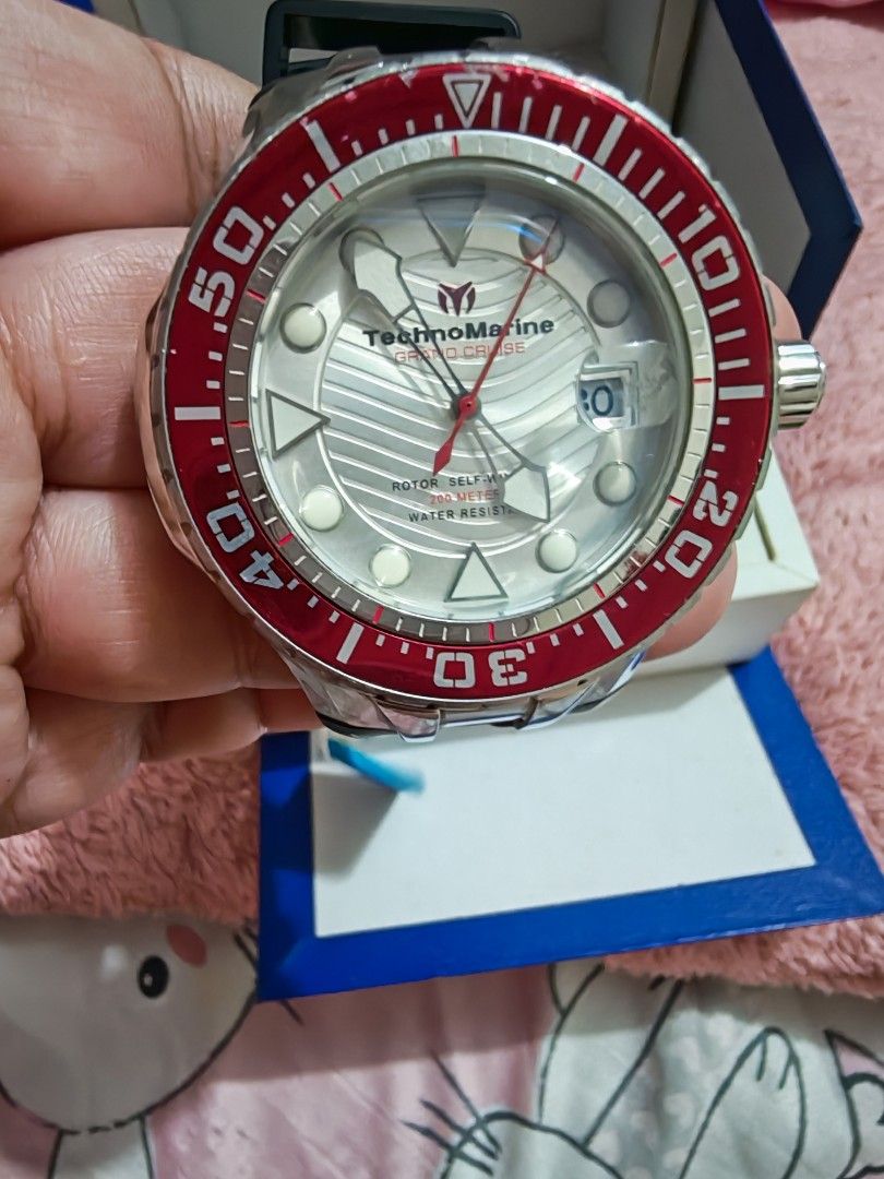 TechnoMarine Cruise Automatic Watch (Category: Men's Watches) located in Taguig. Submitted by voxsummer88 (Listing ID 1422979522, Image 3). Description: - TechnoMarine Cruise Automatic Watch - Bold red bezel - Silver dial with date display - Durable stainless steel case - Comfortable black rubber strap - Includes original box and tag - Features a view of the automatic movement -unisex watch.