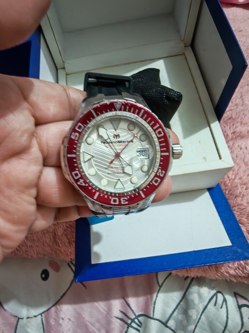 TechnoMarine Cruise Automatic Watch (Category: Men's Watches) located in Taguig. Submitted by voxsummer88 (Listing ID 1422979522, Image 2). Description: - TechnoMarine Cruise Automatic Watch - Bold red bezel - Silver dial with date display - Durable stainless steel case - Comfortable black rubber strap - Includes original box and tag - Features a view of the automatic movement -unisex watch.