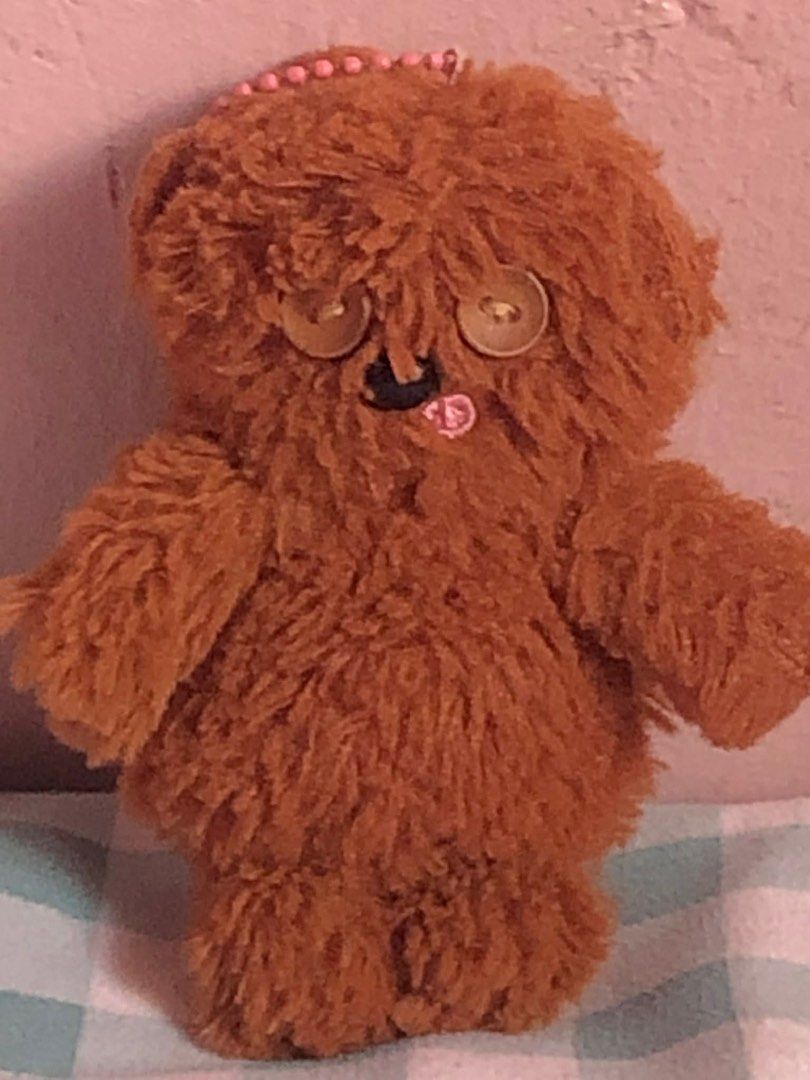 Tim Bear Brown Teddy Bear Plushie (Category: Plushies & Soft Toys) located in Manila. Submitted by 102598iris (Listing ID 1422913940, Image 3). Description: - Handmade brown teddy bear plushie - Features button eyes and a cute pink tongue - Adorned with a small pink beaded crown - Fluffy texture - Small and easy to carry - Ideal for collectors or as a unique gift.
