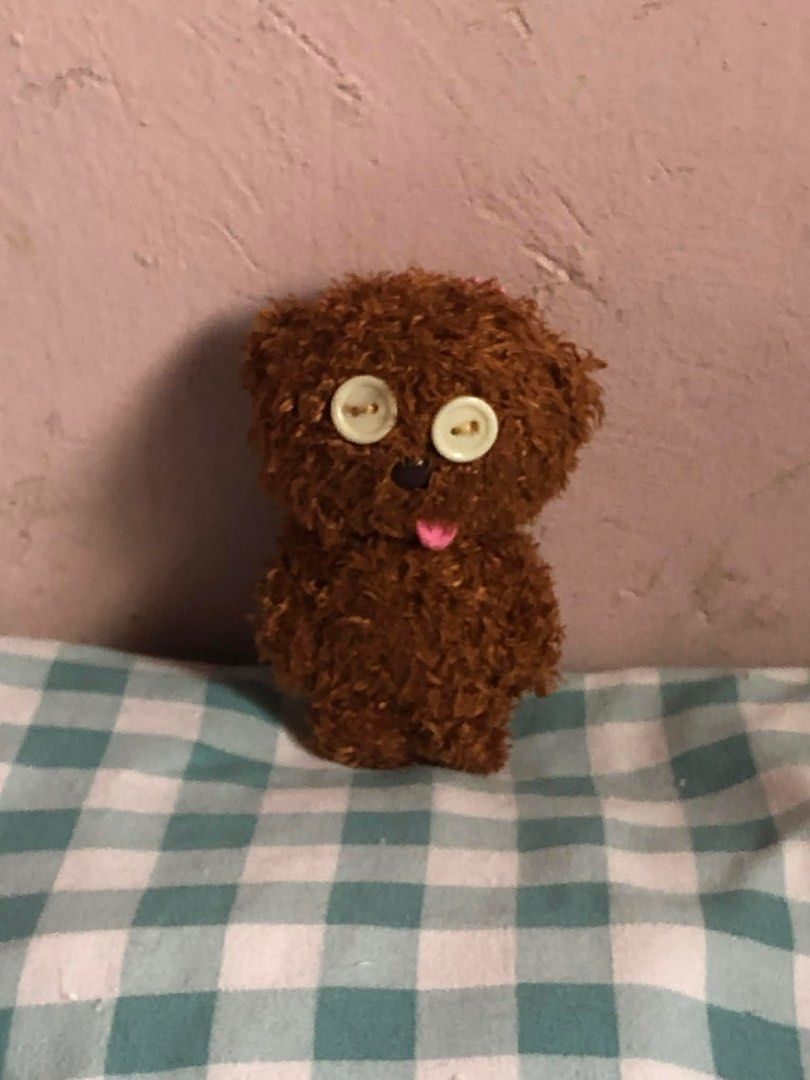 Tim Bear Brown Teddy Bear Plushie (Category: Plushies & Soft Toys) located in Manila. Submitted by 102598iris (Listing ID 1422914099, Image 3). Description: - Handmade teddy bear plushie - Features button eyes, black nose, and pink tongue - Made of brown, textured material - Includes a pink beaded chain - Small size, perfect for display - Ideal gift for collectors.