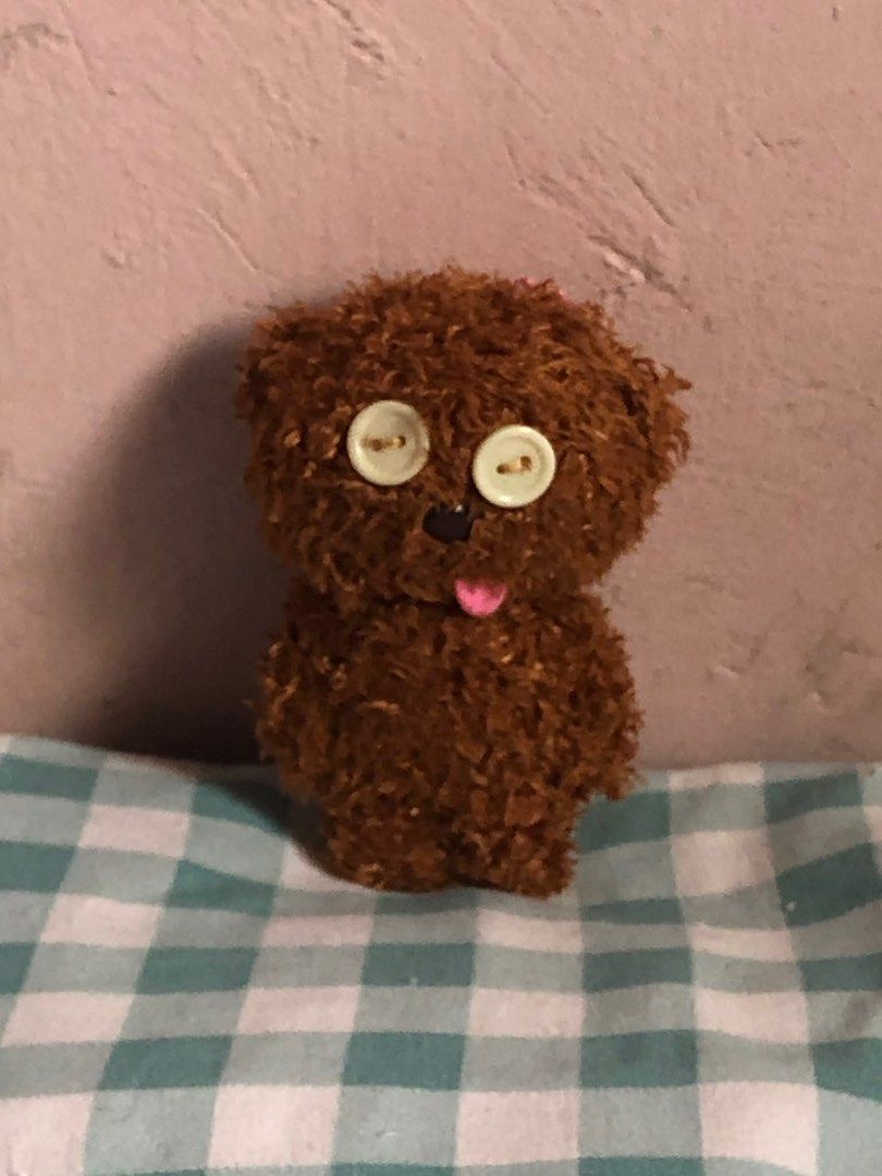Tim Bear Brown Teddy Bear Plushie (Category: Plushies & Soft Toys) located in Manila. Submitted by 102598iris (Listing ID 1422914099, Image 2). Description: - Handmade teddy bear plushie - Features button eyes, black nose, and pink tongue - Made of brown, textured material - Includes a pink beaded chain - Small size, perfect for display - Ideal gift for collectors.