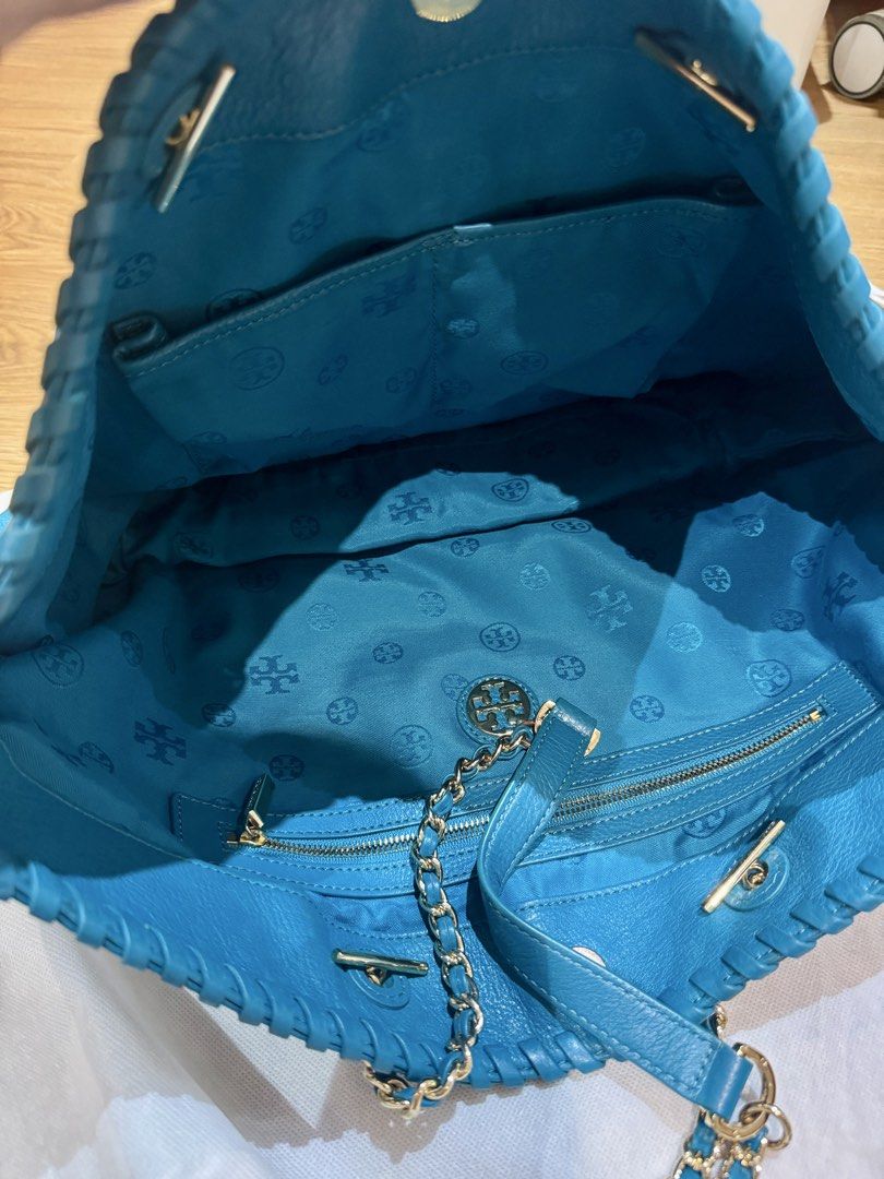 Tory Burch Blue Leather Chain Tote Bag (Category: Luxury Bags & Wallets) located in Manila. Submitted by declutterkween14 (Listing ID 1422963146, Image 3). Description: - Authentic Tory Burch tote bag - Vibrant blue color - Stylish chain strap - Spacious interior with multiple compartments - Stitched design details - Iconic Tory Burch logo on front - Branded interior lining.