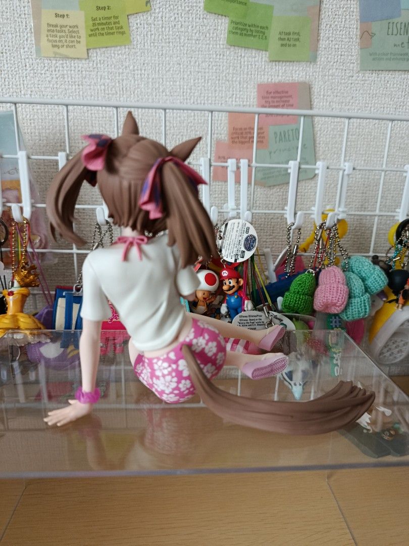 Uma Musume Pretty Derby Figure (Category: Figurines & Statues) located in Bacoor. Submitted by etcee.ph (Listing ID 1422925456, Image 2). Description: pink -SOLD - Uma Musume Pretty Derby figure - Relaxed pose - Outfit: White shirt, pink floral shorts, sandals - Hair: Brown with pink and purple accents - Features: Sitting on a clear base, includes tail.
