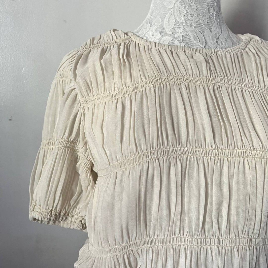 Vintage Cream Ruched Top (Category: Blouses) located in San Mateo. Submitted by prelouve (Listing ID 1423038796, Image 2). Description: - Cream-colored crop top - Features a ruched design - Short, puffed sleeve.