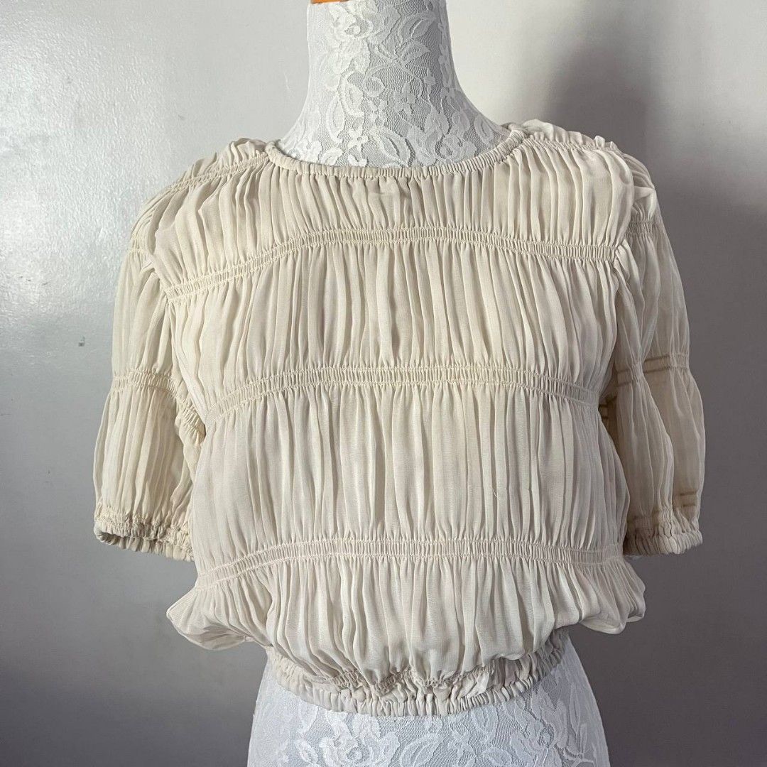 Vintage Cream Ruched Top (Category: Blouses) located in San Mateo. Submitted by prelouve (Listing ID 1423038796, Image 1). Description: - Cream-colored crop top - Features a ruched design - Short, puffed sleeve.