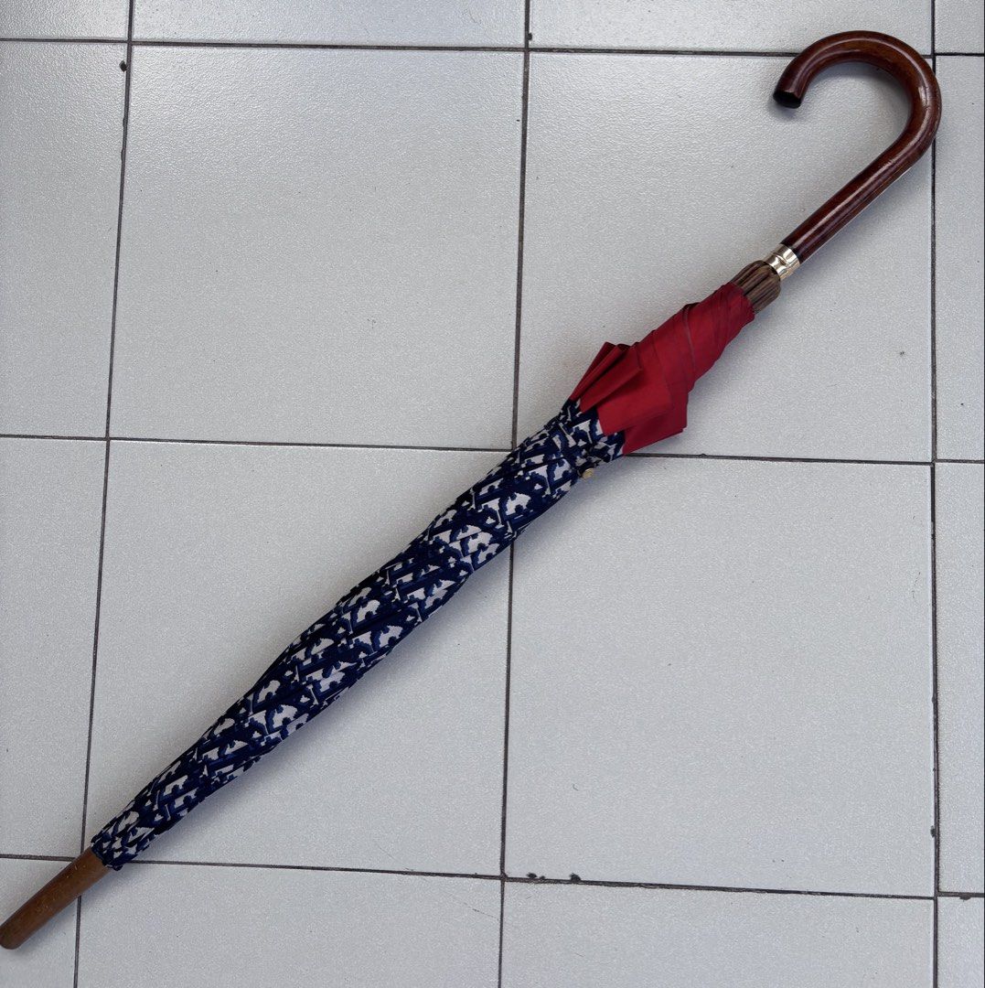 Vintage Dior Trotter Umbrella (Category: Umbrellas) located in Mabalacat. Submitted by pawcats (Listing ID 1423039174, Image 1). Description: - Vintage Dior Trotter Umbrella - Features the iconic Trotter pattern - Elegant design with red trim - A stylish accessory - Very Good Condition - No issue.