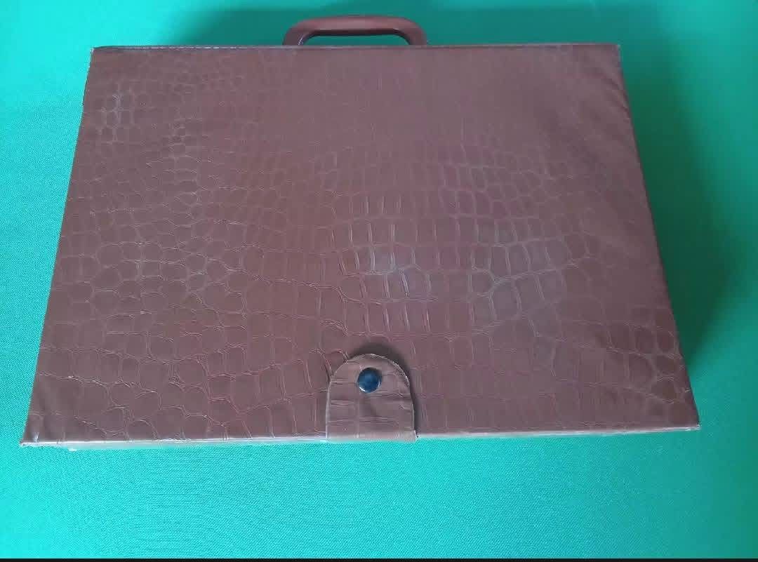 Vintage Mahjong Set with Case (Category: Board Games & Puzzles) located in San Pablo. Submitted by vennisa.sportssupplies (Listing ID 1422972490, Image 2). Description: - Complete vintage Mahjong set - Includes tiles, dice, and racks - Comes in a brown case - Features a handle and button closure - Tiles feature various symbols and characters - Full set of tiles included - Ready for play.
