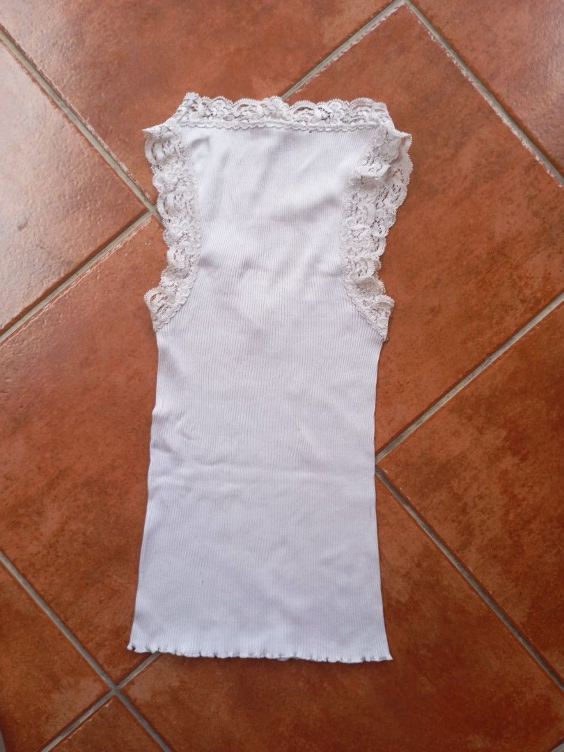 White Ribbed Tank Top with Lace Trim (Category: Sleeveless) located in Manila. Submitted by beenab (Listing ID 1422960964, Image 2). Description: - White ribbed tank top - Delicate lace trim on neckline and straps - V-neck design - Fitted silhouette - Soft, lightweight fabric - Perfect for layering or wearing alone.