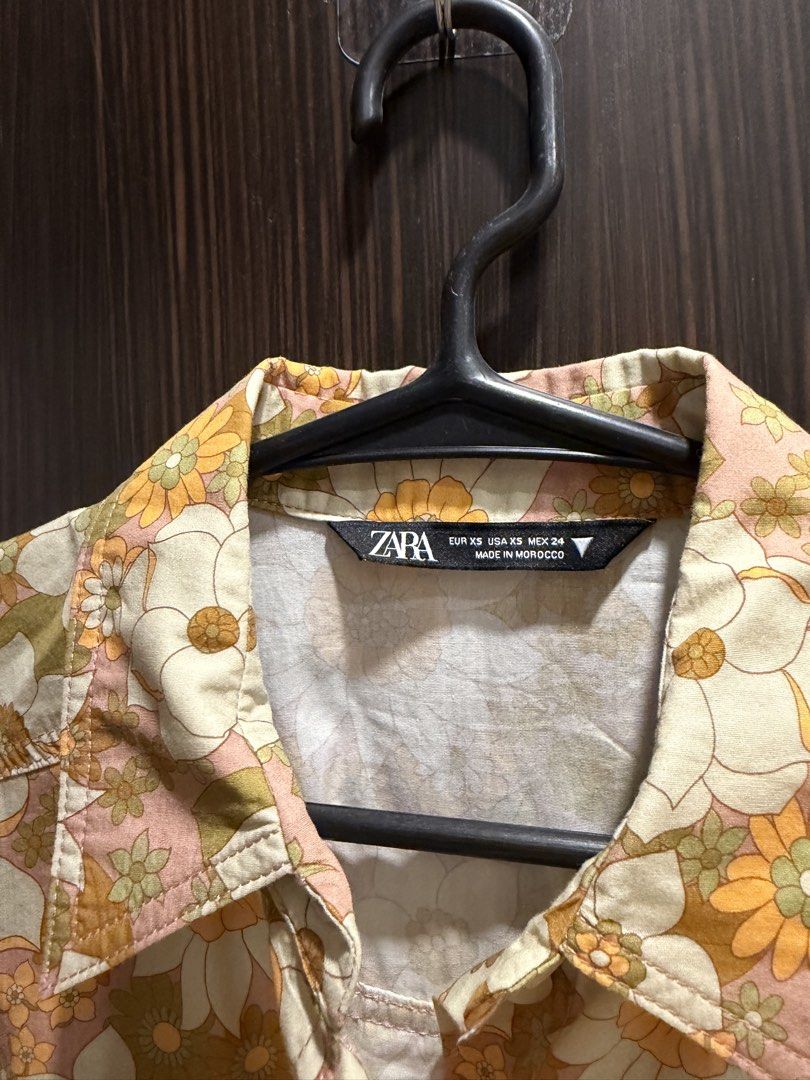 Zara Floral Print Shirt (Category: Shirts) located in Las Pinas. Submitted by celineyuch (Listing ID 1422904411, Image 2). Description: - Zara floral print shirt - Size: XS (but im usually a medium and it fits me hehe) - Colorful floral pattern - Short sleeves - Two front pockets - Button-down closure - Collared neckline - Perfect for casual wear - Never used! Washed and stored only :).