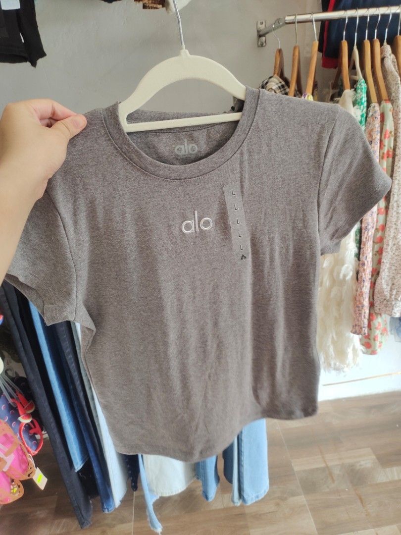 Alo Crew Neck T-shirt 250 each (Category: Shirts) located in Cabanatuan. Submitted by shoppbbykk (Listing ID 1423214207, Image 2). Description: - Alo crew neck t-shirts - Available colors: Gray, Brown, Black - Features the Alo logo - Soft and comfortable material - Ideal for everyday wear and workouts - Size tag visible.