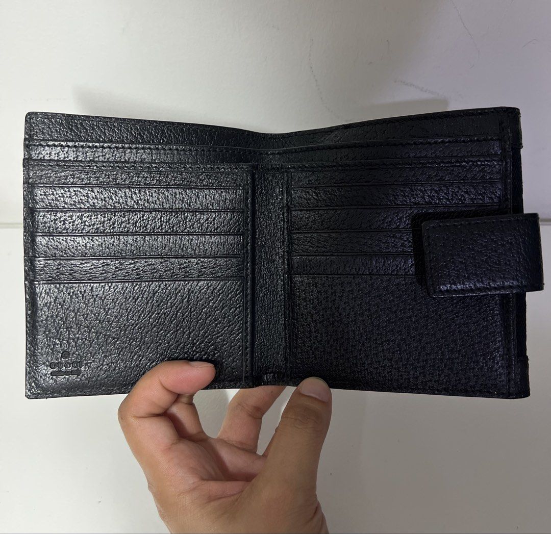 Authentic Gucci GG Black Bi-fold Wallet (Category: Luxury Bags & Wallets) located in Manila. Submitted by importgoodiesph (Listing ID 1423157990, Image 3). Description: Authentic Gucci Bifold Wallet - in excellent condition - classic black GG monogram canvas with black leather trim and a snap tab closure - 10 card slots, 1 coin purse and 2 note compartments - approx. dimensions (W4.5in, H4in, D0.75in) - made in Italy LBC shipping.