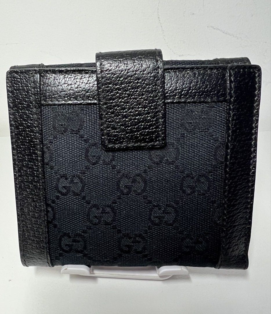 Authentic Gucci GG Black Bi-fold Wallet (Category: Luxury Bags & Wallets) located in Manila. Submitted by importgoodiesph (Listing ID 1423157990, Image 2). Description: Authentic Gucci Bifold Wallet - in excellent condition - classic black GG monogram canvas with black leather trim and a snap tab closure - 10 card slots, 1 coin purse and 2 note compartments - approx. dimensions (W4.5in, H4in, D0.75in) - made in Italy LBC shipping.