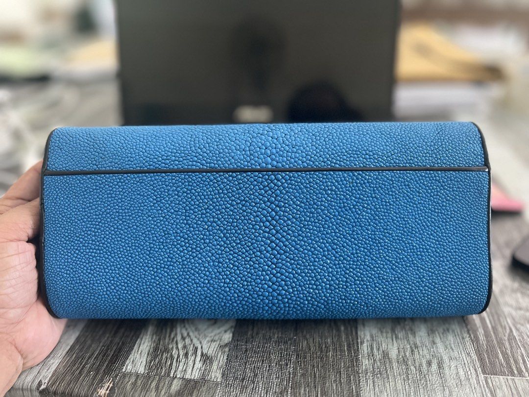Blue Stingray Leather Clutch Bag (Category: Clutches) located in Daanbantayan. Submitted by christinet58475 (Listing ID 1423146588, Image 2). Description: - Blue stingray leather clutch bag - Unique white eye-shaped design - Black interior with zippered pocket and card slots - Detachable black strap for shoulder or crossbody wear - Suitable for casual and formal events.