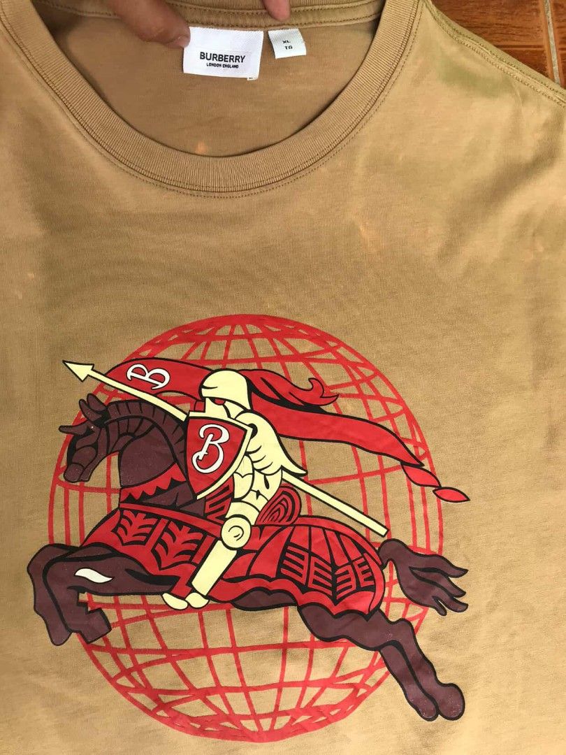 Burberry Knight Graphic Tee XL (Category: Tshirts & Polo Shirts ) located in Manila. Submitted by ronmark (Listing ID 1423212106, Image 2). Description: - Burberry T-shirt - Features a knight graphic - Color: Tan - Size: XL - Crew neck and short sleeves - Made in London, England.