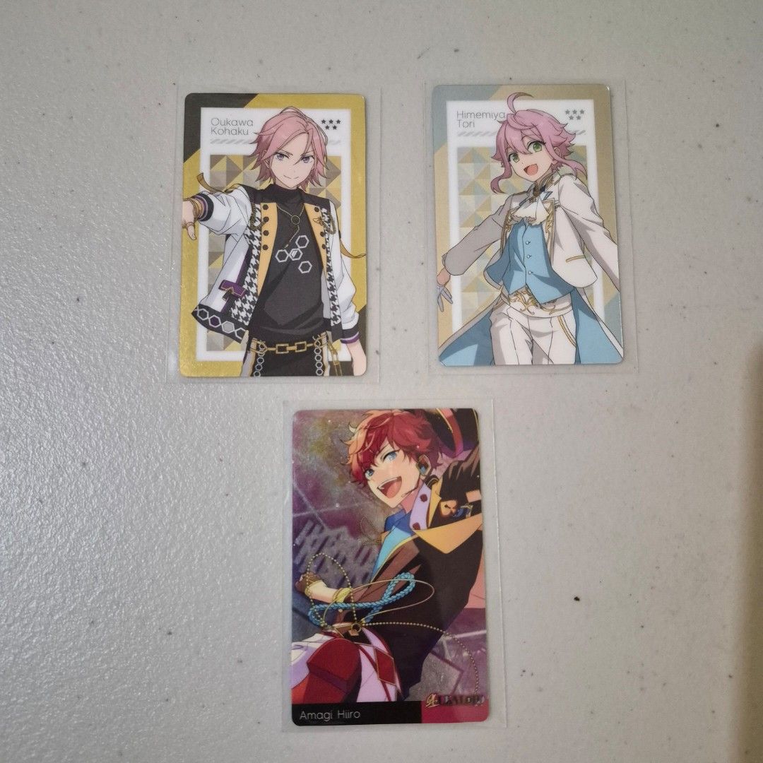 Ensemble Stars! Trading Cards (Category: Raw Singles) located in Cebu City. Submitted by snuggleplushph (Listing ID 1423186500, Image 1). Description: - Ensemble Stars! trading card set. - Featuring characters like Oukawa Kohaku and Amagi Hiro. - Cards are in protective sleeves. - Includes cards with a blue-tinted design. - Backs of cards show the Ensemble Stars! logo and character names..