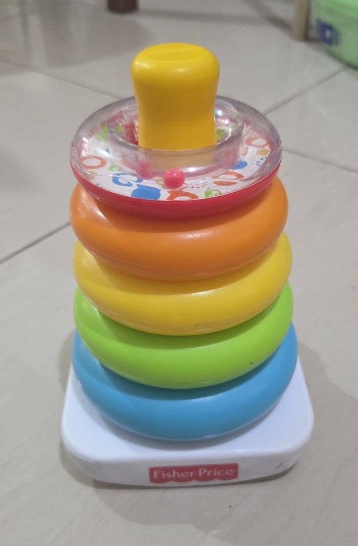 Fisher-Price Stacking Rings Toy (Category: Infant Playtime) located in Marikina City. Submitted by emcanindo (Listing ID 1423167004, Image 1). Description: - Fisher-Price Stacking Rings - Includes a sturdy base and colorful rings - Rings in blue, green, yellow, orange, and red - Features a yellow top - Base with Fisher-Price logo - Helps babies develop hand-eye coordination - Teaches about sizes and colors.