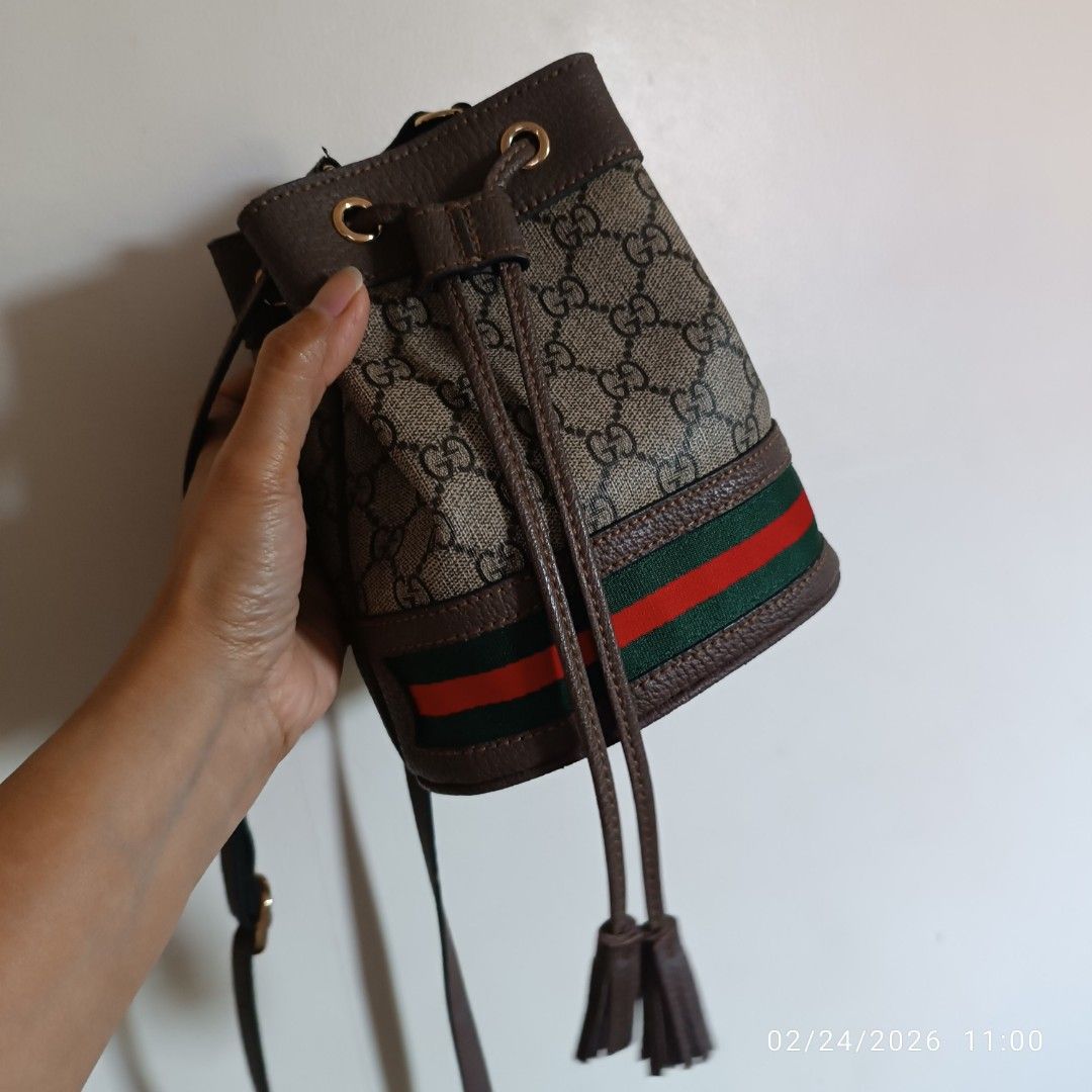 Gucci Bucket Bag (Category: Luxury Bags & Wallets) located in Bacoor. Submitted by pamelott (Listing ID 1423102526, Image 3). Description: - Gucci bucket bag - Iconic GG monogram print - Drawstring closure - Shoulder strap - Brown leather trim - Green and red stripe detail - Light brown interior - Minor wear on strap - Bought in Vietnam.