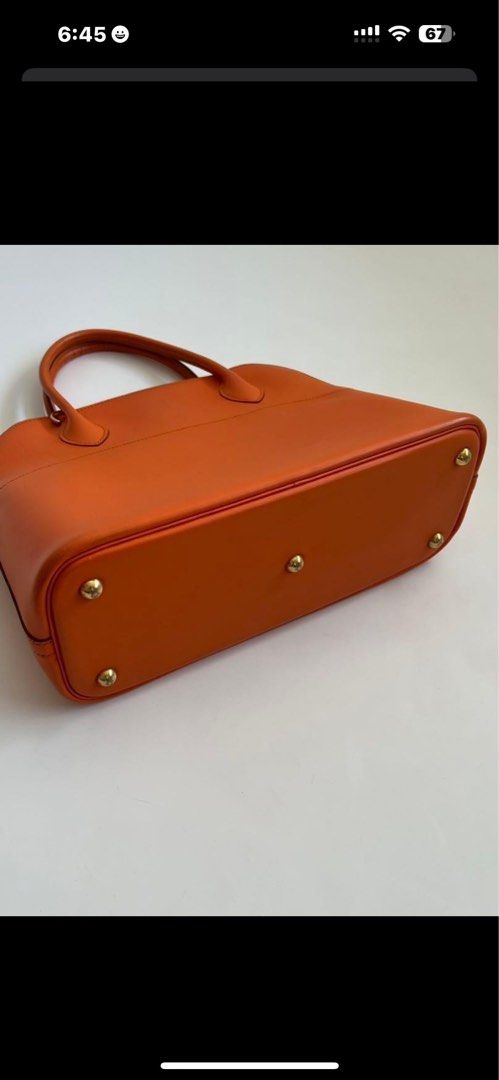 Hermes Bolide Orange Leather Handbag (Category: Luxury Bags & Wallets) located in Malolos. Submitted by yamaguchionline (Listing ID 1423085292, Image 3). Description: - Authentic Hermes handbag - Crafted from orange leather - Includes top handle and detachable shoulder strap - Secure zip closure - Elegant gold-tone hardware - Interior features Hermes stamp - Protective feet on the bottom - Made in France.