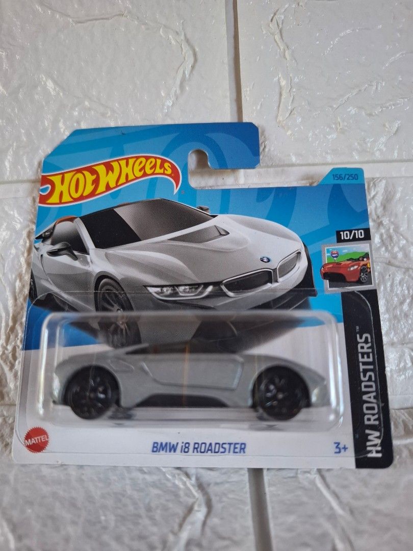 Hot Wheels BMW i8 Roadster (Category: Vehicle & Diecast Models) located in Narvacan. Submitted by jigger85_2ndaccount (Listing ID 1423104611, Image 1). Description: - Hot Wheels BMW i8 Roadster diecast car - Silver color with black wheels - Part of the HW Roadsters series - Includes original packaging - Packaging features car design and Hot Wheels logo.
