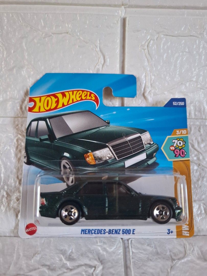 Hot Wheels Mercedes-Benz 500 E (Category: Vehicle & Diecast Models) located in Narvacan. Submitted by jigger85_2ndaccount (Listing ID 1423105260, Image 1). Description: Hot Wheels Mercedes-Benz 500 E diecast car. It is part of the 70s and 90s series. The car is dark green. The packaging includes the Hot Wheels logo and the number 3/10. The car is in its original packaging..