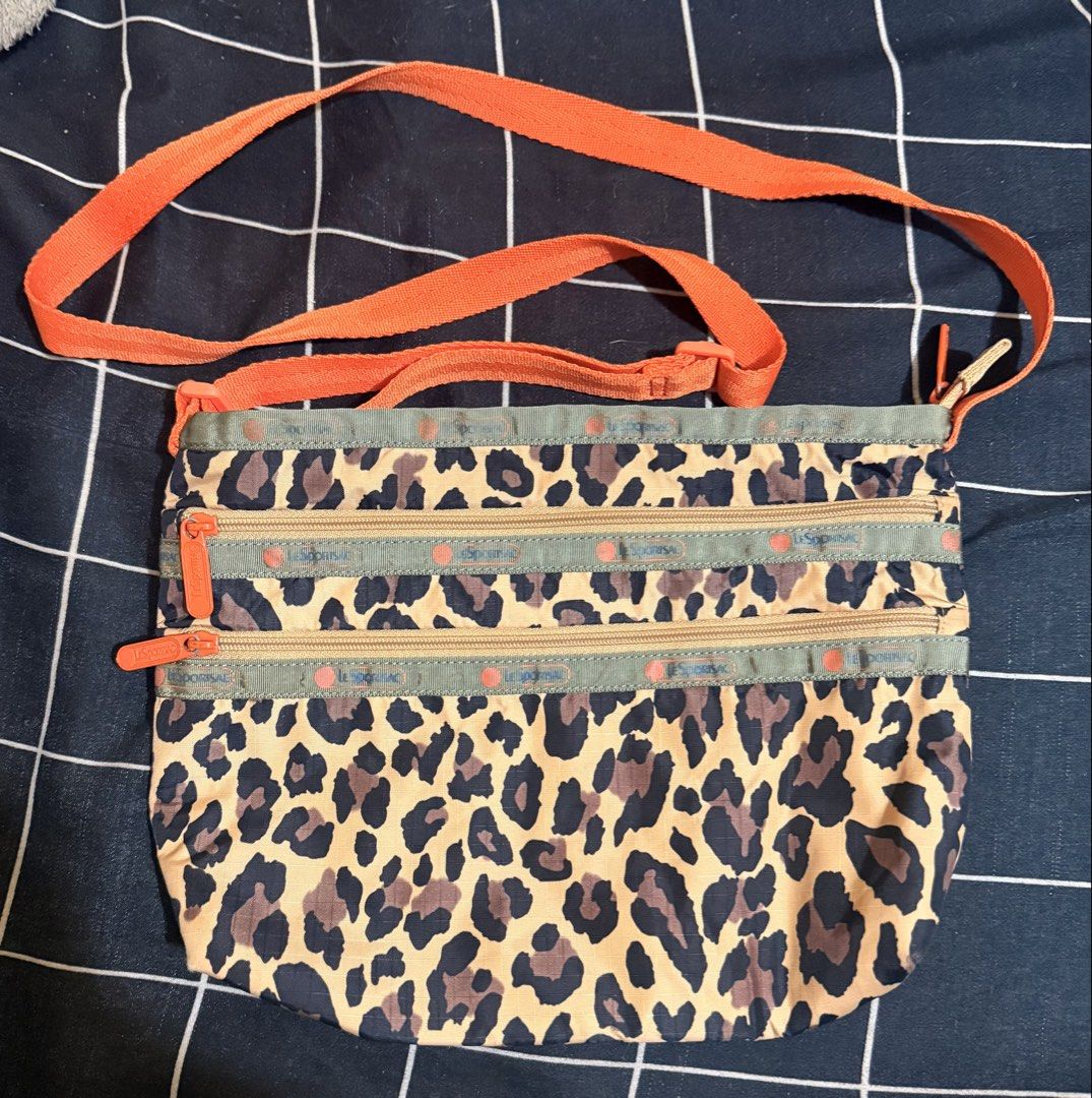 LeSportsac Leopard Print Crossbody Bag (Category: Cross-body Bags) located in Marikina City. Submitted by aanna05 (Listing ID 1423210796, Image 1). Description: - LeSportsac crossbody bag - Eye-catching leopard print - Three zippered compartments for organization - Adjustable orange strap - Made of durable and lightweight material - Compact and easy to carry - Ideal for everyday use RFS: Decluttering Moo: Gcash / GoTyme / Bank Transfer .