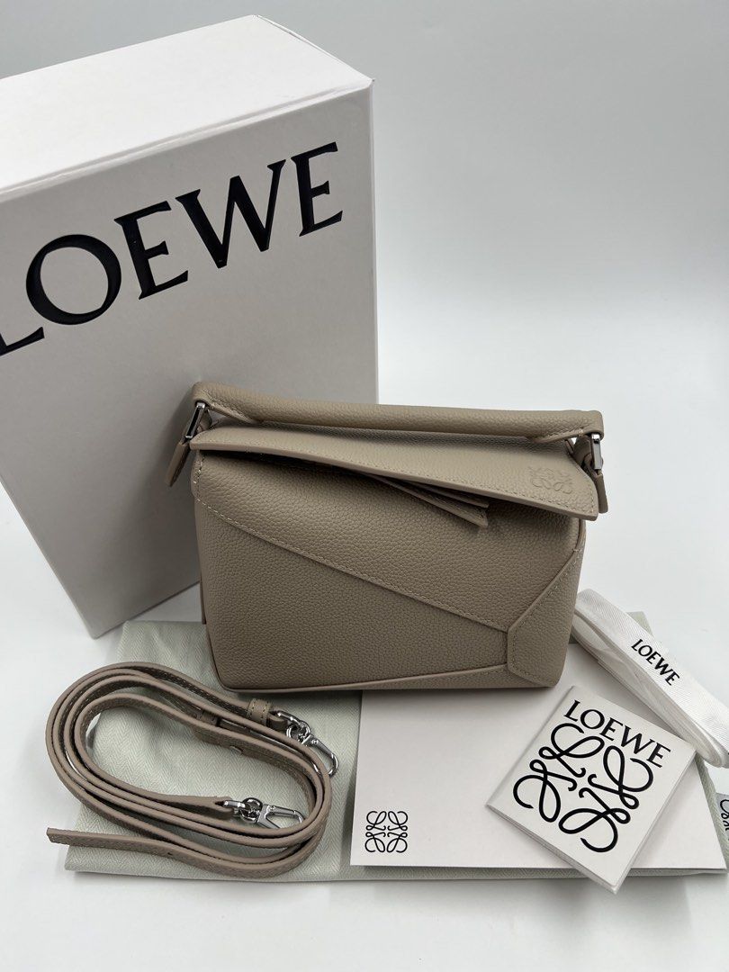 ⚜️Loewe Puzzle - Puzzle Edge Mini Bag (Category: Luxury Bags & Wallets) located in Makati City. Submitted by 90sangel (Listing ID 1423249874, Image 3). Description: •Item: Loewe Puzzle Mini Bag in a neutral tone. •Size: Mini •Condition: Great condition. Rank SA, no hidden issue *Features a top handle and a detachable shoulder strap. Includes the original box, dust bag, and authenticity cards. .