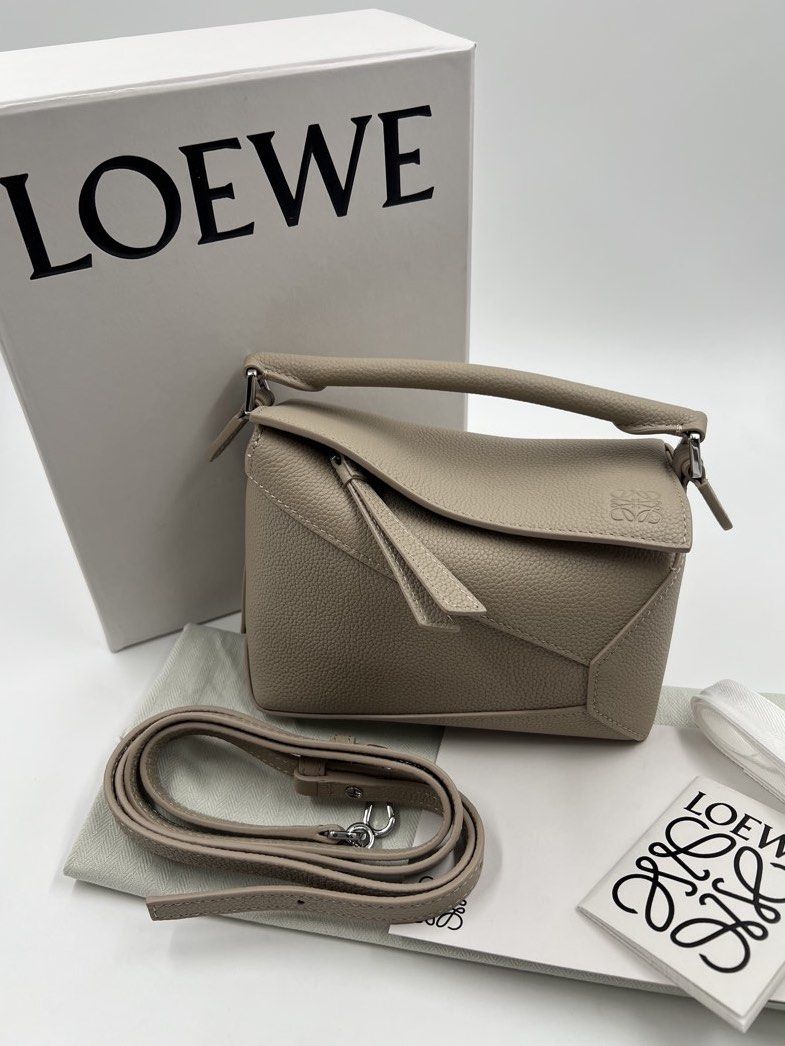 ⚜️Loewe Puzzle - Puzzle Edge Mini Bag (Category: Luxury Bags & Wallets) located in Makati City. Submitted by 90sangel (Listing ID 1423249874, Image 1). Description: •Item: Loewe Puzzle Mini Bag in a neutral tone. •Size: Mini •Condition: Great condition. Rank SA, no hidden issue *Features a top handle and a detachable shoulder strap. Includes the original box, dust bag, and authenticity cards. .