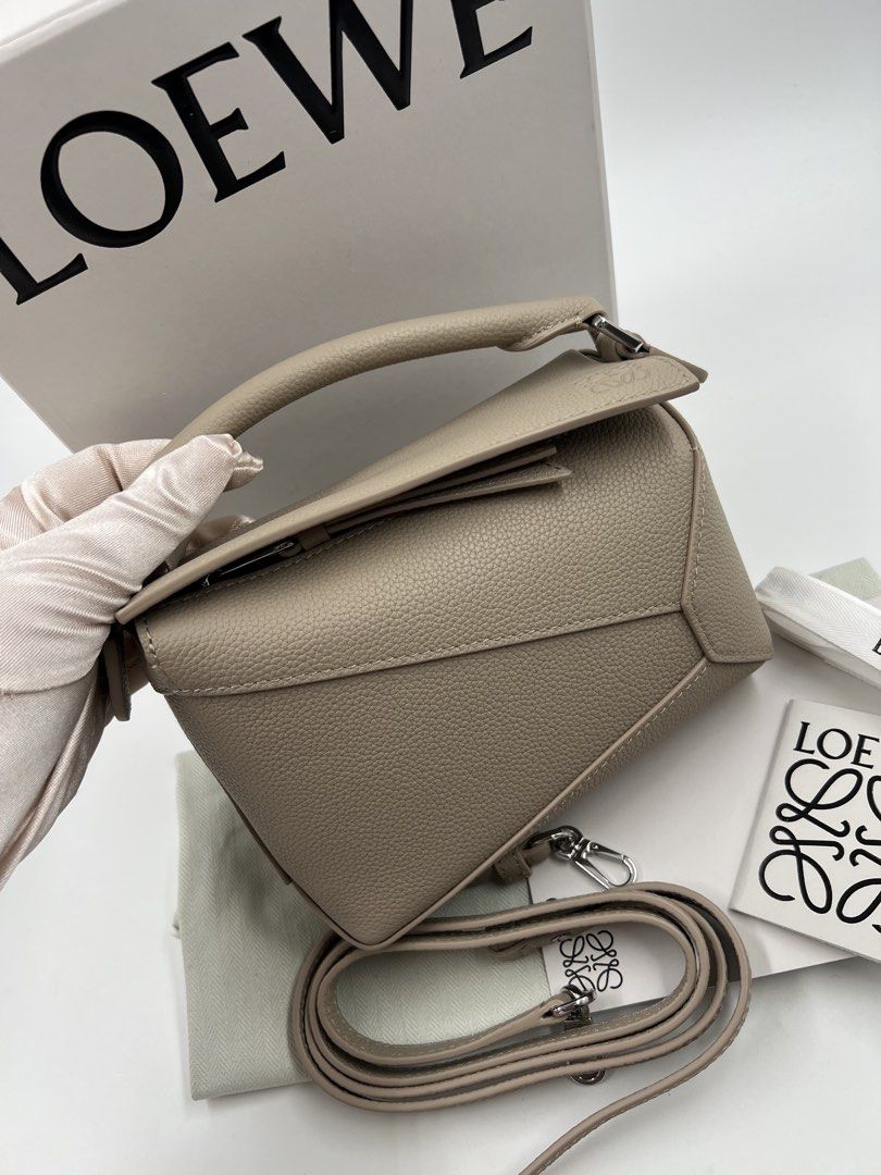 ⚜️Loewe Puzzle - Puzzle Edge Mini Bag (Category: Luxury Bags & Wallets) located in Makati City. Submitted by 90sangel (Listing ID 1423249874, Image 2). Description: •Item: Loewe Puzzle Mini Bag in a neutral tone. •Size: Mini •Condition: Great condition. Rank SA, no hidden issue *Features a top handle and a detachable shoulder strap. Includes the original box, dust bag, and authenticity cards. .