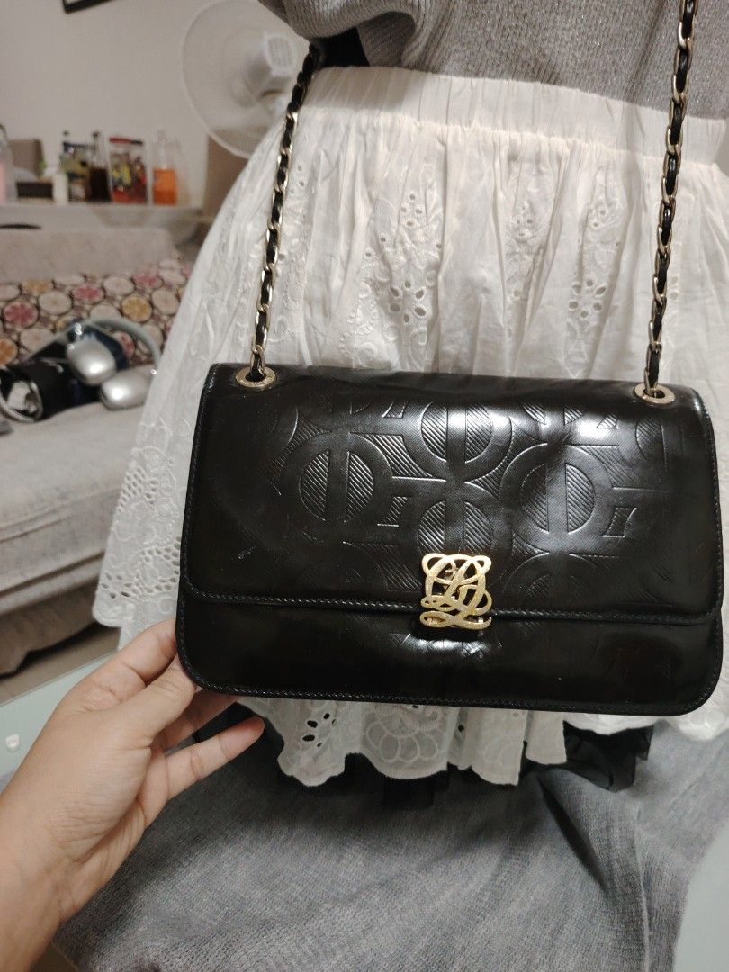 Louis Quatorze Black Chain Shoulder Bag (Category: Shoulder Bags) located in Muntinlupa City. Submitted by jovyrivera0824 (Listing ID 1423182337, Image 3). Description: - Elegant black shoulder bag - Features a gold-toned chain and leather strap - Decorative clasp and embossed pattern - Stylish bow detail on the strap - Classic design, perfect for any occasion -adjustable chain sling, can be shoulder or crossbody bag -multiple compartment.