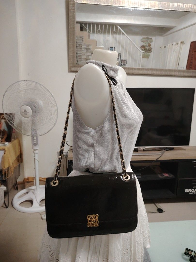 Louis Quatorze Black Chain Shoulder Bag (Category: Shoulder Bags) located in Muntinlupa City. Submitted by jovyrivera0824 (Listing ID 1423182337, Image 1). Description: - Elegant black shoulder bag - Features a gold-toned chain and leather strap - Decorative clasp and embossed pattern - Stylish bow detail on the strap - Classic design, perfect for any occasion -adjustable chain sling, can be shoulder or crossbody bag -multiple compartment.